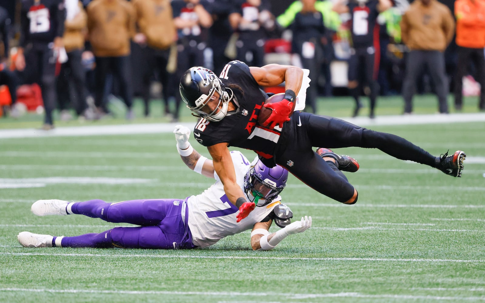 Atlanta Falcons wide receiver Mack Hollins (18) falls short of a first down with Minnesota Vikings cornerback Byron Murphy Jr. (7) defending during the first half of  an NFL football game In Atlanta on Sunday, Nov. 5, 2023 between the Atlanta Falcons and the Minnesota Vikings. (Bob Andres for the Atlanta Journal Constitution)