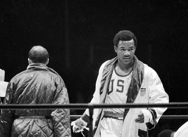 FILE - Heavyweight boxer George Foreman is seen during his bout with Russia's Iones Chepulis during their Olympic finals in Mexico City, Oct. 27, 1968. Foreman captured the gold medal. (AP Photo, File)