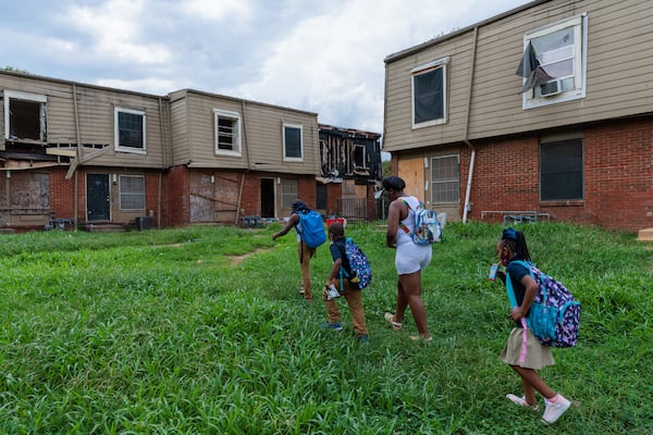 Ayana Meriweather walks with her son and her siblings back to the Forest Cove Apartments in Atlanta after the bus dropped the children off from Slater Elementary School on Thursday, August 18, 2022. (Arvin Temkar / arvin.temkar@ajc.com)