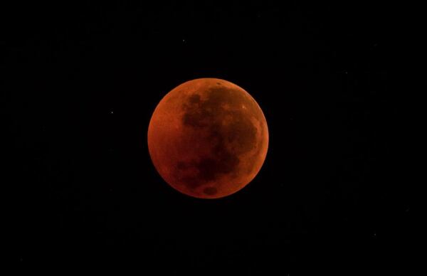 A view of a full moon during a 'blood moon' eclipse on July 28, 2018 in Yogyakarta, Indonesia. Stargazers viewed Friday's total lunar eclipse, which was the longest blood moon visible this century, until 2123.