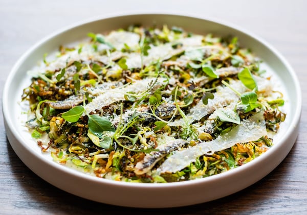 Watershed on Peachtree serves a take on a classic Caesar salad made with Brussels sprouts, guanciale, white anchovies and pistachios. CONTRIBUTED BY HENRI HOLLIS