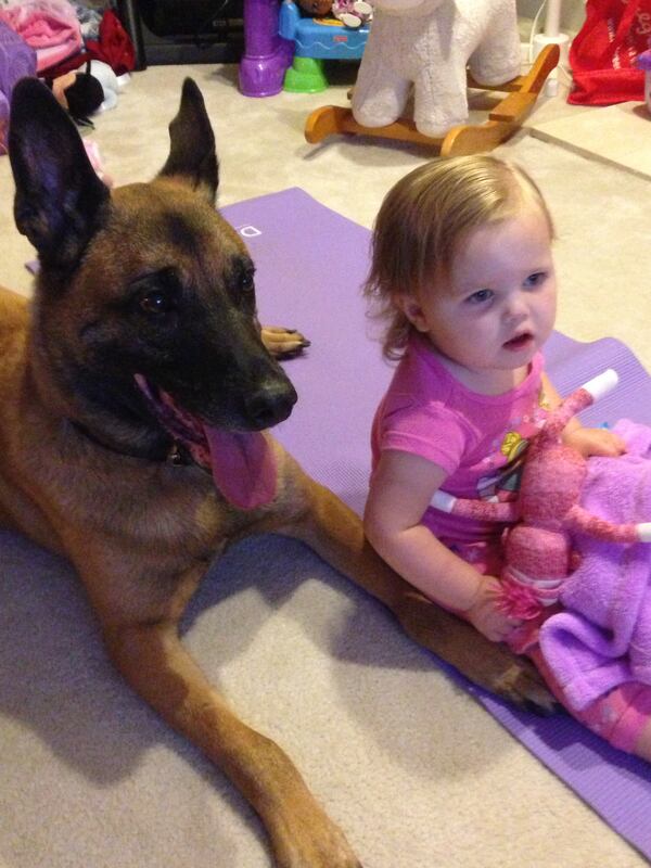 K-9 Chris watches TV with Emily Matson at 1 year old.