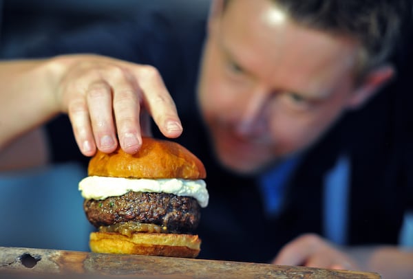 This burger with candied onions, braised bacon and cheddar foam is indicative of the work of chef Richard Blais. Hyosub Shin/hyosub.shin@ajc.com