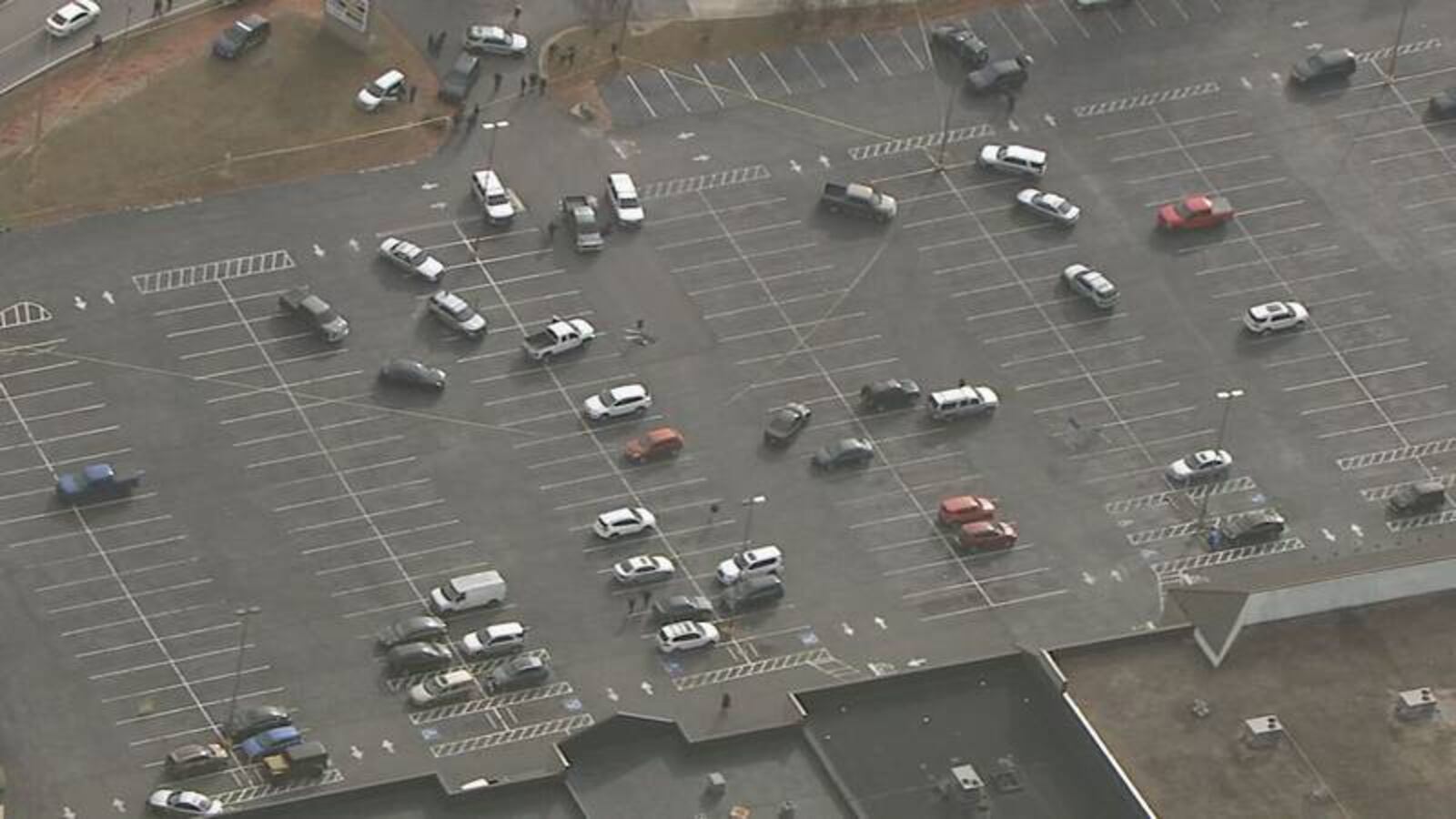 Law enforcement vehicles swarmed the strip mall parking lot after the shooting.