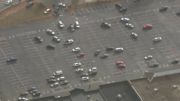 Law enforcement vehicles swarmed the strip mall parking lot after the shooting.