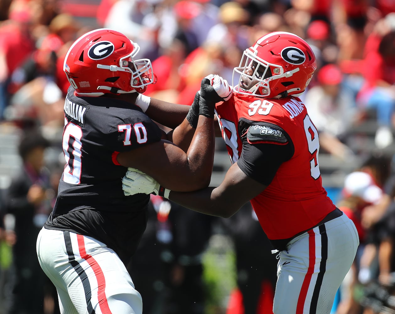 Georgia offensive lineman Daniel Calhoun (left) takes on defensive lineman Joseph Jonah-Ajonye (right).  Curtis Compton for the Atlanta Journal Constitution