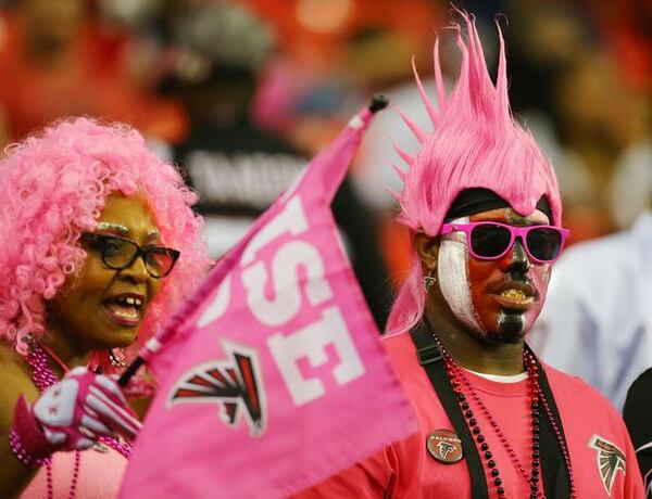 Falcons fans Lula and Charles Motin, LaGrange, wear pink for breast cancer awareness to watch their team give up a ton of explosive plays against the Bears on Sunday, Oct. 12, 2014, in Atlanta. (Curtis Compton)