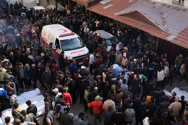 Mourners gather around the bodies of Palestinians who were killed in an Israeli army airstrikes as they are brought to Al-Ahli Hospital in Gaza City, Tuesday, March 18, 2025. (AP Photo/Abdel Kareem Hana)