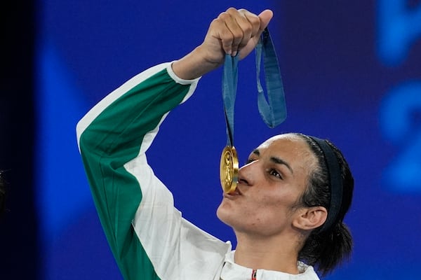 FILE - Gold medalist Algeria's Imane Khelif kisses her medal for the women's 66 kg final boxing match at the 2024 Summer Olympics, Friday, Aug. 9, 2024, in Paris, France. (AP Photo/John Locher, file)