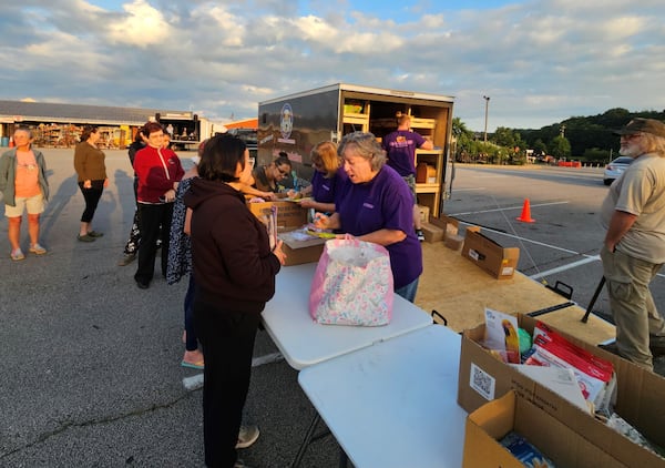 The Pet food Pantry Outreach serves free pet food and necessary resources like beds, blankets and supplements in Commerce and Pendergrass. Here, volunteers Kathie White and Pat Matthews take details of each person's pet to make sure there is enough food and supplies to give. Photo courtesy of Penny Miller