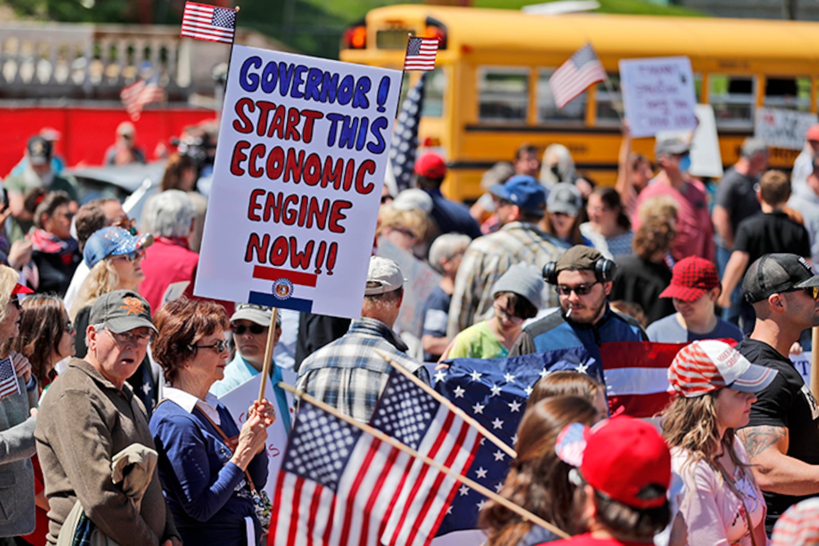 A woman holds a sign as she attends a rally outside the Missouri Capitol to protest stay-at-home orders put into place due to the COVID-19 outbreak. Several hundred people attended the rally to protest the restrictions and urge the reopening of businesses closed in an effort to slow the spread of the coronavirus.