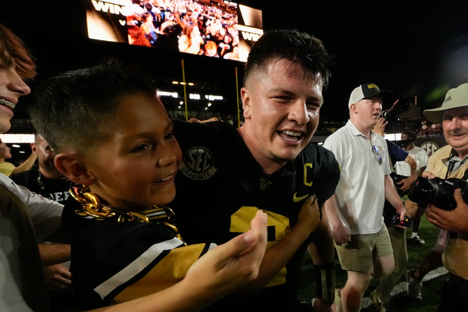 Vanderbilt quarterback Diego Pavia, center, celebrates the team's 40-35 win against Alabama after an NCAA college football game Saturday, Oct. 5, 2024, in Nashville, Tenn. (AP Photo/George Walker IV)