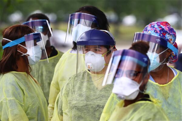 Dozens of specimen collection volunteers are on hand to take free COVID-19 tests at a pop-up site at the House of Hope on May 4, in Decatur. Increased testing does not explain the surge of new virus cases in Georgia, experts say. CURTIS COMPTON CCOMPTON@AJC.COM