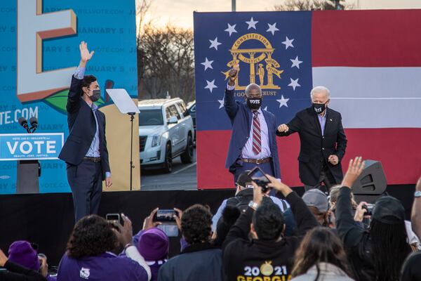 01/04/2021 — Atlanta, Georgia — US Senate Democrat candidates Jon Ossoff (left) and Rev. Raphael Warnock (center) join the stage with President-elect Joe Biden (right) following his remarks during a campaign rally in Atlanta’s Summerhill neighborhood, Monday, January 4, 2021. (Alyssa Pointer / Alyssa.Pointer@ajc.com)