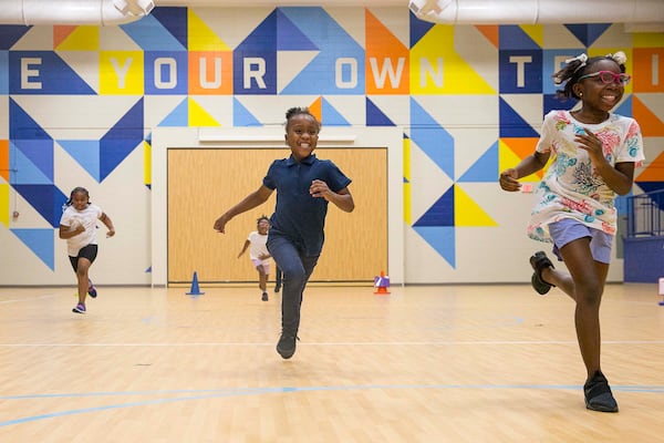 Harper-Archer Elementary School third grader Mahogany Love (right) is leading the pack as she and her peers participate in a race during an after school program in the school's gym, Wednesday, October 2, 2019. (ALYSSA POINTER/ALYSSA.POINTER@AJC.COM)