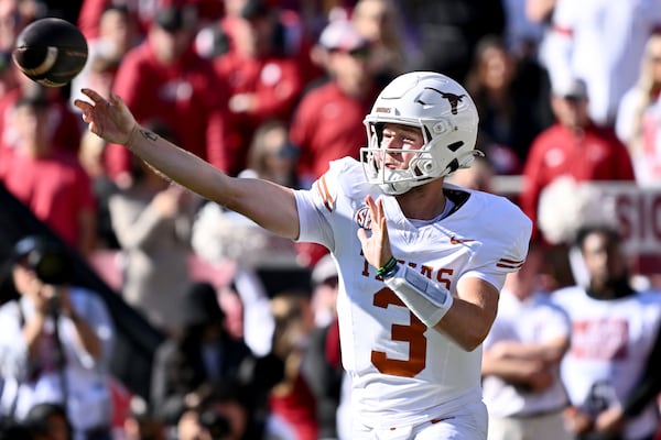 Texas quarterback Quinn Ewers (3) throws a pass during the first half of an NCAA college football game against Arkansas, Saturday, Nov. 16, 2024, in Fayetteville, Ark. (AP Photo/Michael Woods)