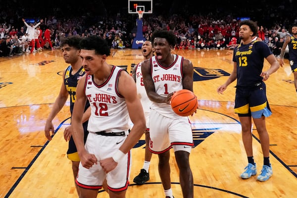 St. John's's Kadary Richmond (1) celebrates after RJ Luis Jr. (12) scored during the first half of an NCAA college basketball game against the Marquette in the semifinals of the Big East tournament Friday, March 14, 2025, in New York. (AP Photo/Frank Franklin II)