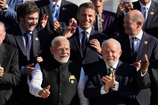 India's Prime Minister Narendra Modi, front left, Brazil's President Luiz Inacio Lula da Silva, front right, Argentina's President Javier Milei, top left, France's President Emmanuel Macron, top center, and Germany's Chancellor Olaf Scholz pose for a group photo during the G20 summit in Rio de Janeiro, Monday, Nov. 18, 2024. (AP Photo/Eraldo Peres)