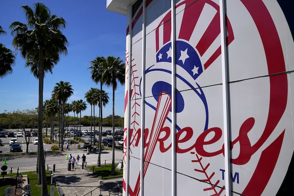 FILE - Fans arrive at George M. Steinbrenner Field for a spring training exhibition baseball game between the New York Yankees and the Pittsburgh Pirates in Tampa, Fla., Saturday, March 13, 2021. (AP Photo/Gene J. Puskar