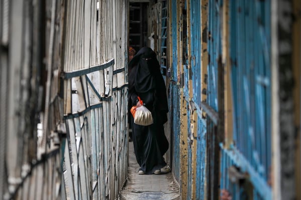 A Palestinian woman walks out of a bakery in Gaza City, Monday, Feb. 24, 2025. (AP Photo/Abdel Kareem Hana)