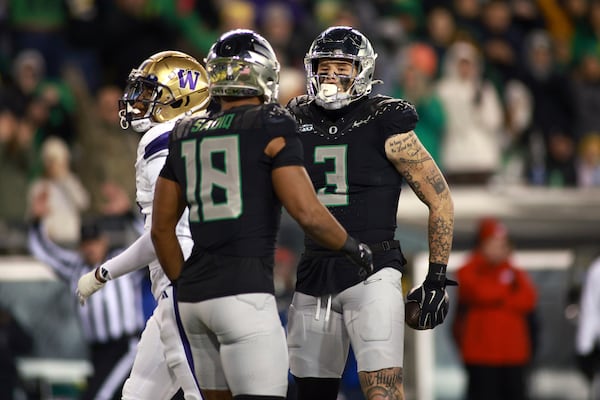 Oregon tight end Kenyon Sadiq (18) congratulates tight end Terrance Ferguson (3) on a first down during an NCAA college football game against Washington, Saturday, Nov. 30, 2024, in Eugene, Ore. (AP Photo/Lydia Ely)