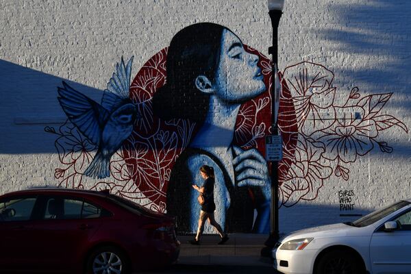 A mural on Poplar Street in downtown Macon, an avenue that has been a focal point of revival in this two-century-old city. (Hyosub Shin / AJC)