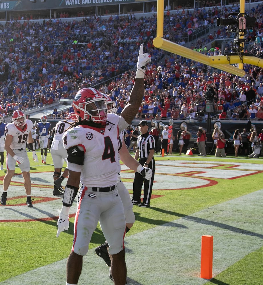 10/30/21 - Jacksonville -  Georgia Bulldogs running back James Cook (4) celebrates after he scored Georgia's first touchdown during the first half of the annual NCCA  Georgia vs Florida game at TIAA Bank Field in Jacksonville.   Bob Andres / bandres@ajc.com