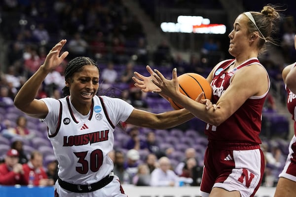 Louisville guard Jayda Curry (30) is stripped of the ball by Nebraska's Callin Hake, right, in the second half in the first round of the NCAA college basketball tournament in Fort Worth, Texas, Friday, March 21, 2025. (AP Photo/Tony Gutierrez)