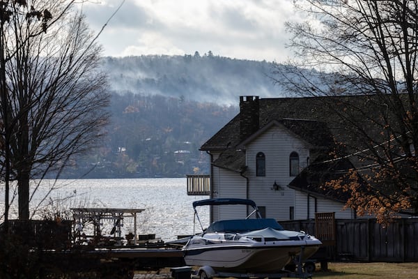 Smoke rises from a wildfire in a forested mountain area across from Greenwood Lake, Monday, Nov. 11, 2024, in Warwick, New York. (AP Photo/Stefan Jeremiah)