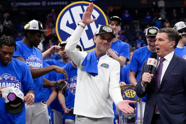 Florida head coach Todd Golden and players celebrate victory over Tennessee after an NCAA college basketball game in the final round of the Southeastern Conference tournament, Sunday, March 16, 2025, in Nashville, Tenn. (AP Photo/George Walker IV)