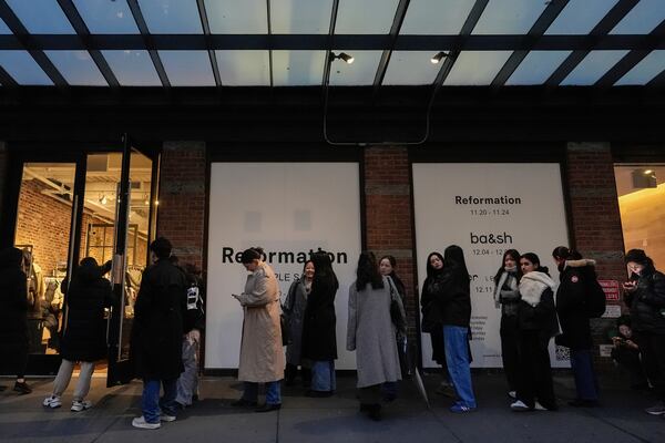 People wait in line for a sample sale in the Meatpacking District of Manhattan, Friday, Nov. 22, 2024, in New York. (AP Photo/Julia Demaree Nikhinson)