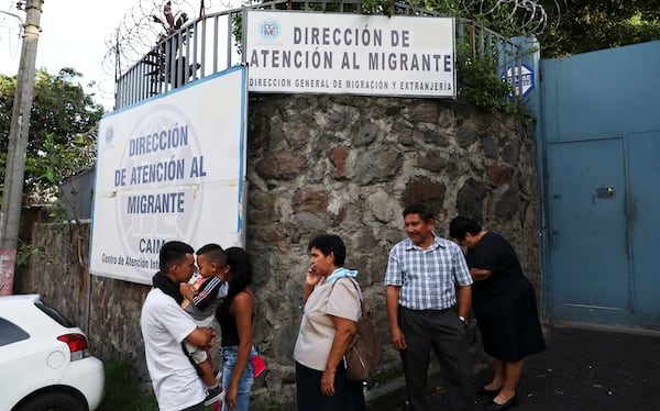 FILE - People gather outside the Migrant Assistance Office on Oct. 9, 2019 in San Salvador, El Salvador. (AP Photo/Eduardo Verdugo, File)