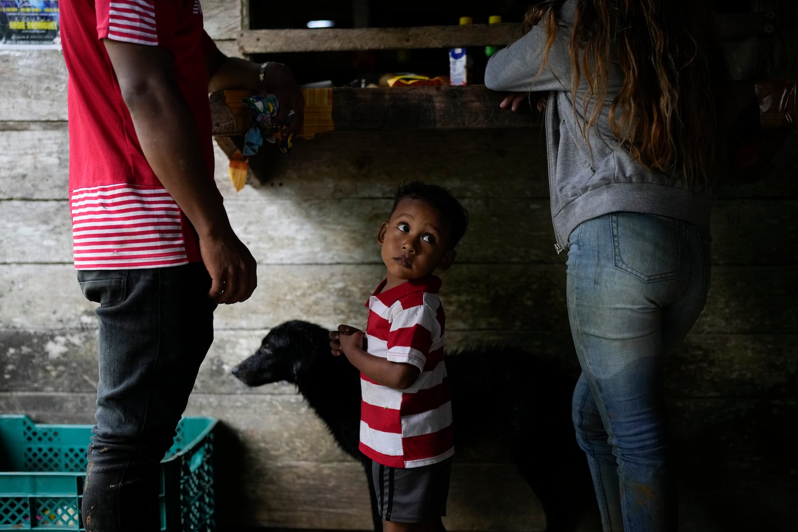 Jadiel Magallon waits as his parents grocery shop in the community of Limon, which could be submerged in a proposed plan to dam the nearby Indio River to secure the Panama Canal’s uninterrupted operation, in Panama, Saturday, Aug. 31, 2024. (AP Photo/Matias Delacroix)