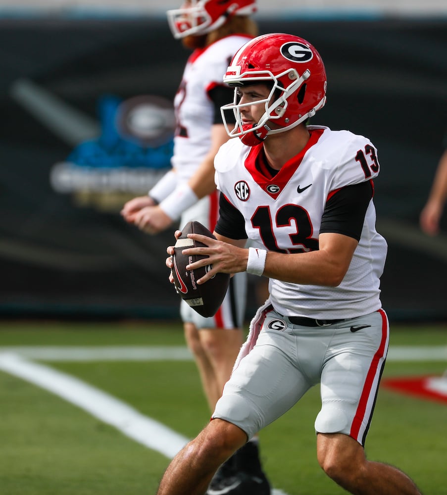 10/30/21 - Jacksonville -  Georgia Bulldogs quarterback Stetson Bennett (13) warms up before the game at the annual NCCA  Georgia vs Florida game at TIAA Bank Field in Jacksonville.   Bob Andres / bandres@ajc.com