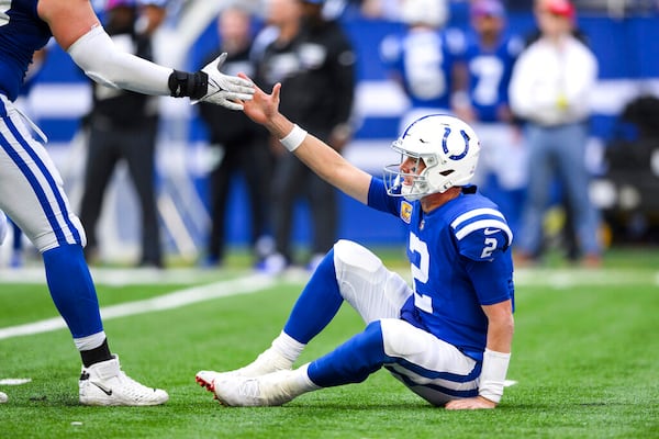 Indianapolis Colts quarterback Matt Ryan (2) gets help off the ground after getting hit during an NFL football game against the Jacksonville Jaguars, Sunday, Oct. 16, 2022, in Indianapolis. (AP Photo/Zach Bolinger)