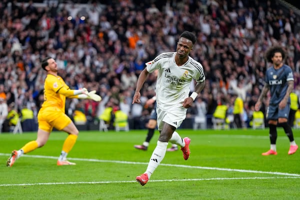 Real Madrid's Vinicius Junior celebrates after scoring his side's second goal during the Spanish La Liga soccer match between Real Madrid and Rayo Vallecano at the Santiago Bernabeu stadium in Madrid, Spain, Sunday, March 9, 2025. (AP Photo/Manu Fernandez)