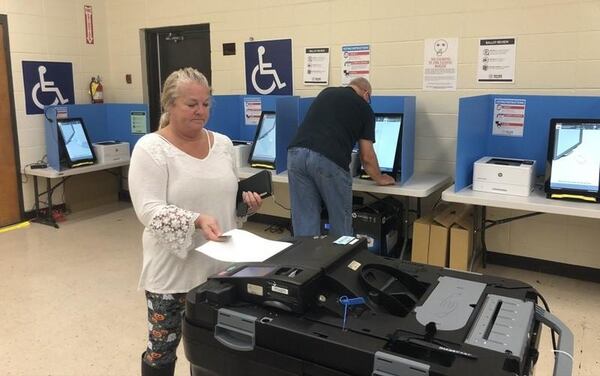 Cathy Watkins of Cartersville inserts her printed-out ballot into a scanner Thursday after voting on Georgia’s new voting machines. Voters in six counties across the state, including Bartow County and its city of Cartersville, are testing the new voting system in this fall’s elections. Voters across Georgia will use the machines in the March 24 presidential primary. MARK NIESSE / MARK.NIESSE@AJC.COM