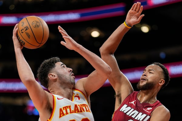 Atlanta Hawks forward Georges Niang (20) shoots against Miami Heat forward Kyle Anderson (20) during the first half of an NBA basketball game, Monday, Feb. 24, 2025, in Atlanta. (AP Photo/Mike Stewart)