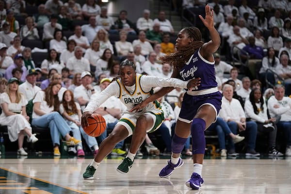 Baylor guard Yaya Felder, left, works to shoot as TCU guard Agnes Emma-Nnopu, right, defends in the first half of an NCAA college basketball game in Waco, Texas, Sunday, March 2, 2025. (AP Photo/Tony Gutierrez)