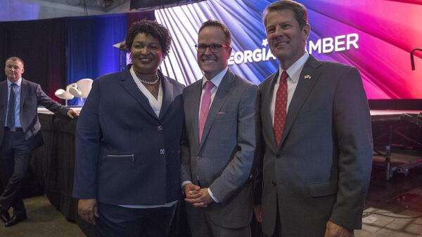 Georgia gubernatorial candidates Stacey Abrams and Brian Kemp, right, stand Tuesday with Georgia Chamber of Commerce President and CEO Chris Clark following the group’s Congressional Luncheon at the Macon Marriott City Center. Both candidates used the forum to explain their plans for Georgia’s economy. (ALYSSA POINTER/ALYSSA.POINTER@AJC.COM)