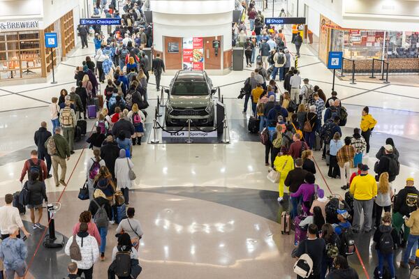 Travelers stand in line to go through the security checkpoint at Hartsfield-Jackson Atlanta International Airport during a busy Friday morning, October 28, 2022. (Steve Schaefer/steve.schaefer@ajc.com)