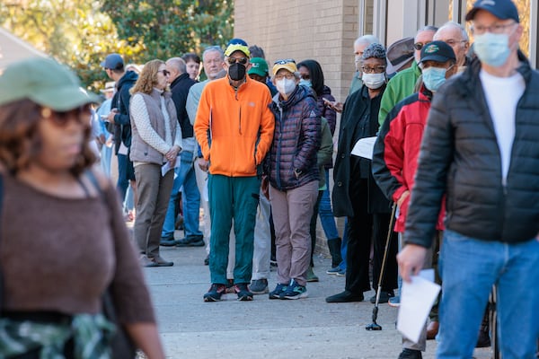 Dekalb County voters wait in line at the Tucker-Reid H. Cofer Library in in November to vote early in the state's 2022 U.S. Senate runoff. (Arvin Temkar / arvin.temkar@ajc.com)