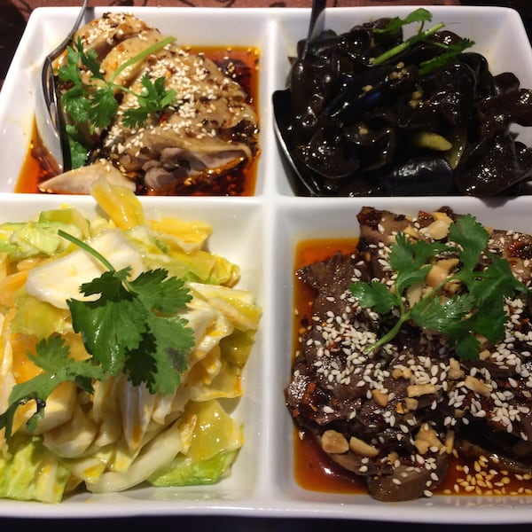 Yummy Spicy’s Yummy Platter of cold appetizers consists of (clockwise from upper left) hot and numbing chicken, pickled wood-ear mushrooms, beef tendon and tripe in chili sauce and pickled cabbage. CONTRIBUTED BY WENDELL BROCK