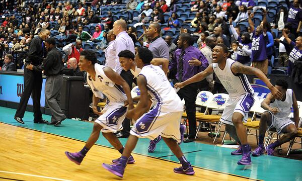 MARCH 7 2014 MACON Miller Grove Wolverines players celebrate their win after the game. Coverage of the Class AAAAA boys basketball championship between the Miller Grove Wolverines and the Warner Robins Demons at the Macon Coliseum Friday, March 7, 2014. Miller Grove won 70-43 for their sixth state championship. KENT D. JOHNSON / KDJOHNSON@AJC.COM Miller Grove players dash onto the court after sealing their Class AAAAA championship. (Kent D. Johnson / AJC)