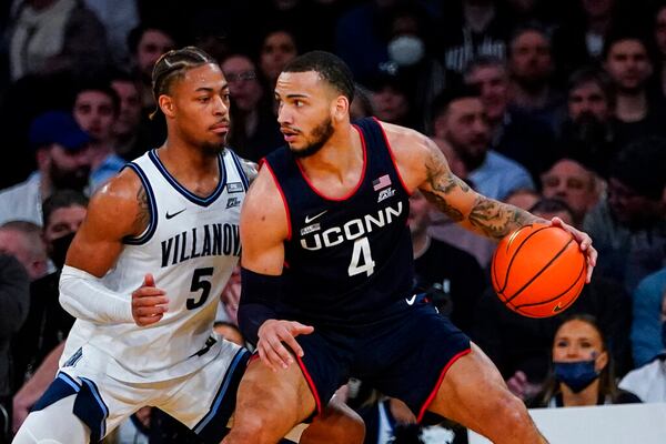 Connecticut's Tyrese Martin (4) dribbled against Villanova during the first half of an NCAA college basketball game in the semifinal round of the Big East conference tournament Friday, March 11, 2022, in New York. (AP Photo/Frank Franklin II)