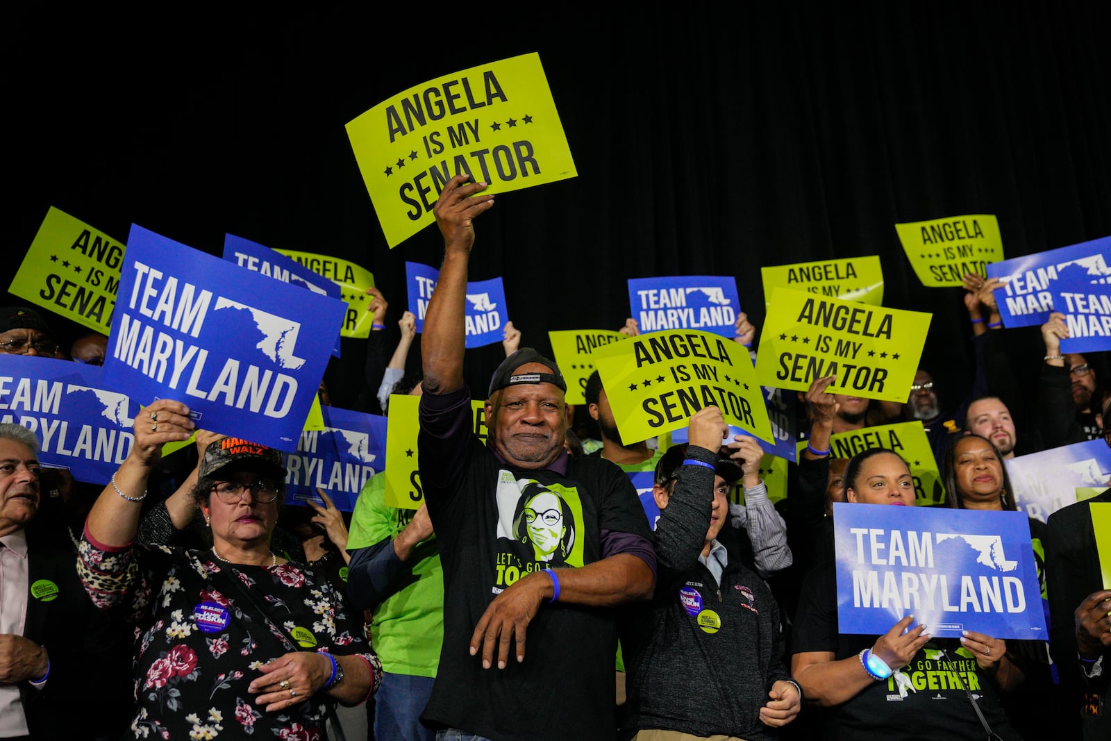 Supporters of Democratic Maryland Senator-elect Angela Alsobrooks hold up signs of support during an election night watch party Tuesday, Nov. 5, 2024, in College Park, Md. (AP Photo/Jess Rapfogel)