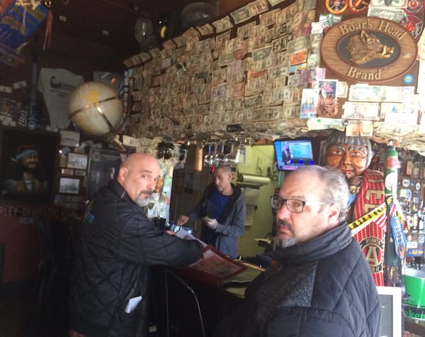 Mike Jakob, left, and his brother Pete, owners of the Elliot Street Deli and Pub, resurrected an old brick building 14 years ago and turned it into a local eatery. Photo by Bill Torpy