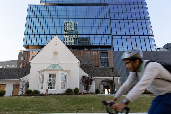 A bicyclist pedals past newly completed office tower Spring Quarter in Atlanta on Monday. Arvin Temkar/AJC