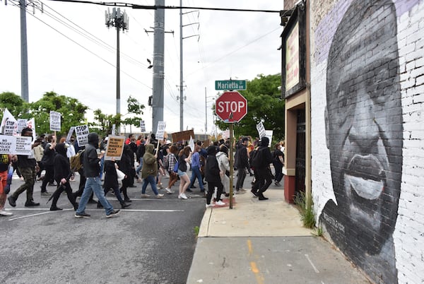 April 14, 2021 Atlanta - Protesters march around the Centennial Olympic Park during a rally in solidarity with Minnesota - Justice for Daunte Wright on Wednesday, April 14, 2021.  (Hyosub Shin / Hyosub.Shin@ajc.com)