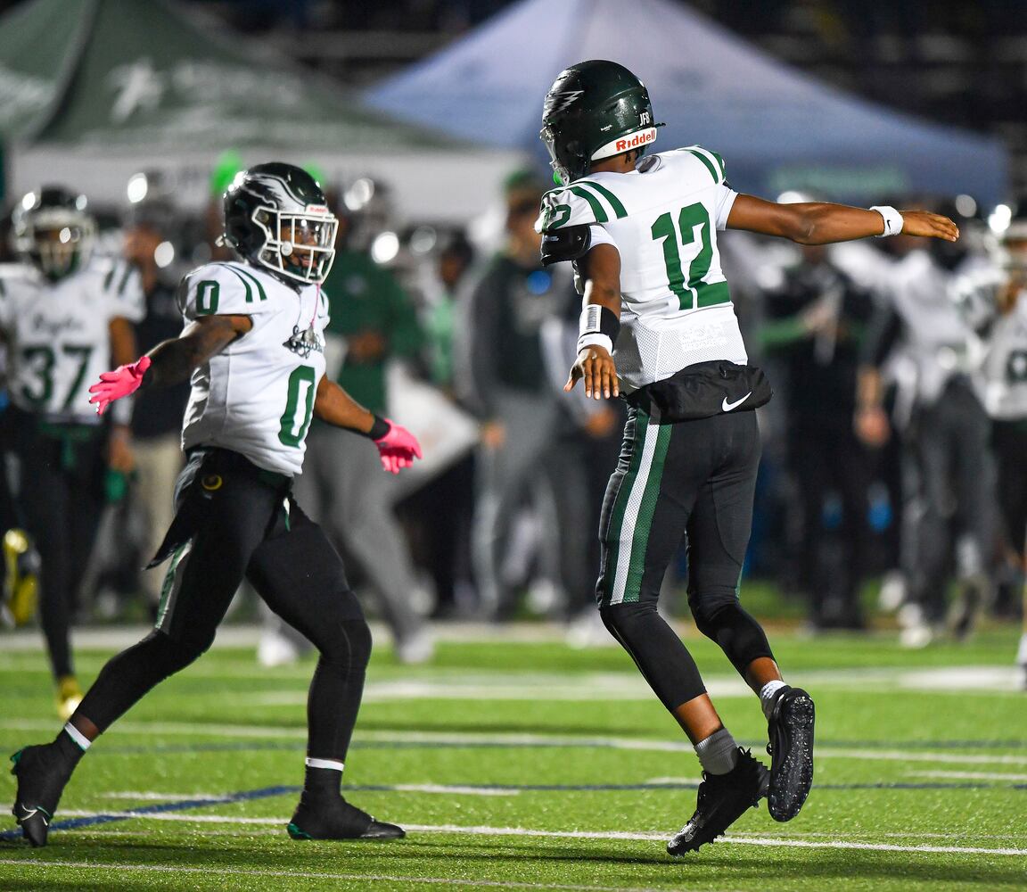 Collins Hill quarterback RJ Wilcox (12) celebrates his touchdown against North Cobb with Jacari Thomas (0) during the first half of play Friday, Nov. 10, 2023 at North Cobb High School. (Daniel Varnado/For the AJC)